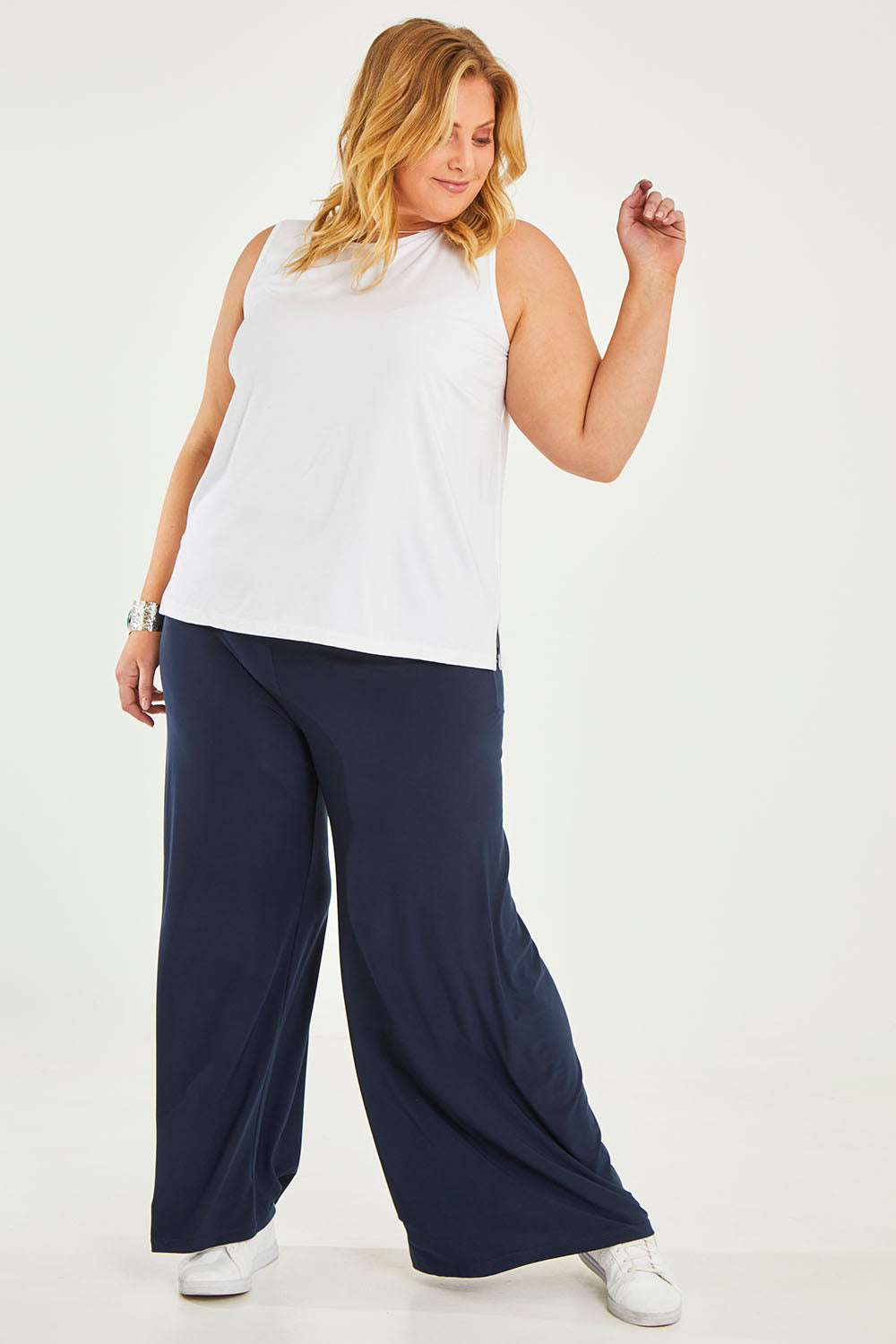 Model Caitlin wearing size 20 of the Belle Luxe Bamboo Tank in colour White (White), from the front, showing the whole outfit
