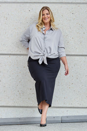 Model Caitlin wearing size 18 of the Belle Ponte Maxi Skirt in colour Black (Black), from the front, showing the whole outfit