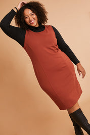 Model Alexis wearing size 16 of the Belle Classic Ponte Sleeveless Dress in colour Ochrerust, from the front, showing the whole outfit