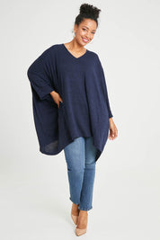 Model Noli wearing size 14 of the Belle Rib Knit Throw Over in colour Navymarle (Blue), from the front, showing the whole outfit