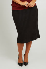 Model Monique wearing size 14 of the Belle Classic Knit Midi Skirt in colour Black (Black), from the front, cropped image