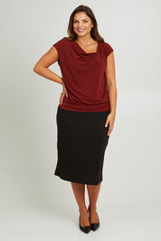 Model Monique wearing size 14 of the Belle Classic Knit Midi Skirt in colour Black (Black), from the front, showing the whole outfit
