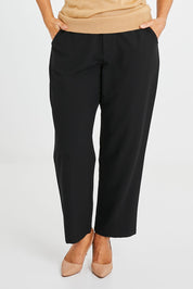 Model Laura wearing size 14 of the Belle Classic Tapered Pant in colour Black (Black), from the front, cropped image