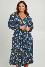 Model Monique wearing size 14 of the Belle Printed Faux Wrap Dress in colour Tealfleur (Green), from the front, cropped image