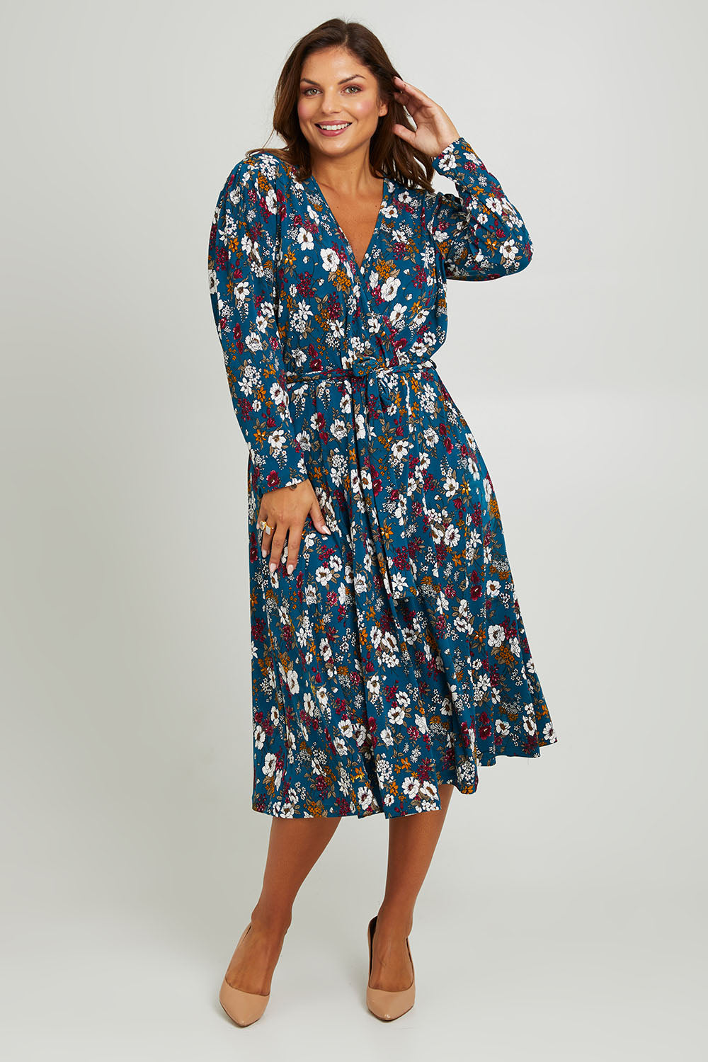 Model Monique wearing size 14 of the Belle Printed Faux Wrap Dress in colour Tealfleur (Green), from the front, showing the whole outfit