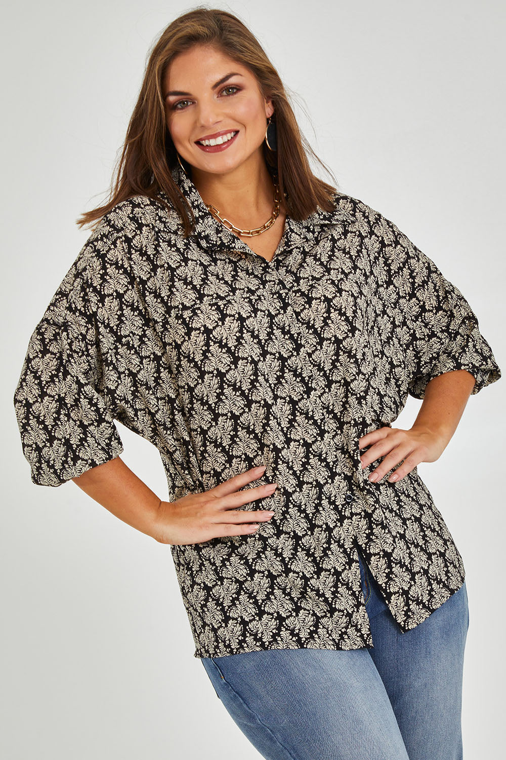 Model Monique wearing size 14 of the Belle Batwing Printed Shirt in colour Blackivory (Black), from the front, showing the whole outfit