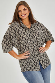 Model Monique wearing size 14 of the Belle Batwing Printed Shirt in colour Blackivory (Black), from the front, showing the whole outfit