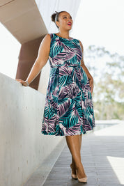 Model Alexis wearing size 18 of the Belle Sleeveless Full Skirt Dress in colour Palmprint (Blue), from the front, showing the whole outfit