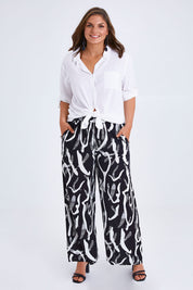 Model Monique wearing size 14 of the Belle Relaxed Wide Leg Pull On Pant in colour Blackivory (Black), from the front, showing the whole outfit
