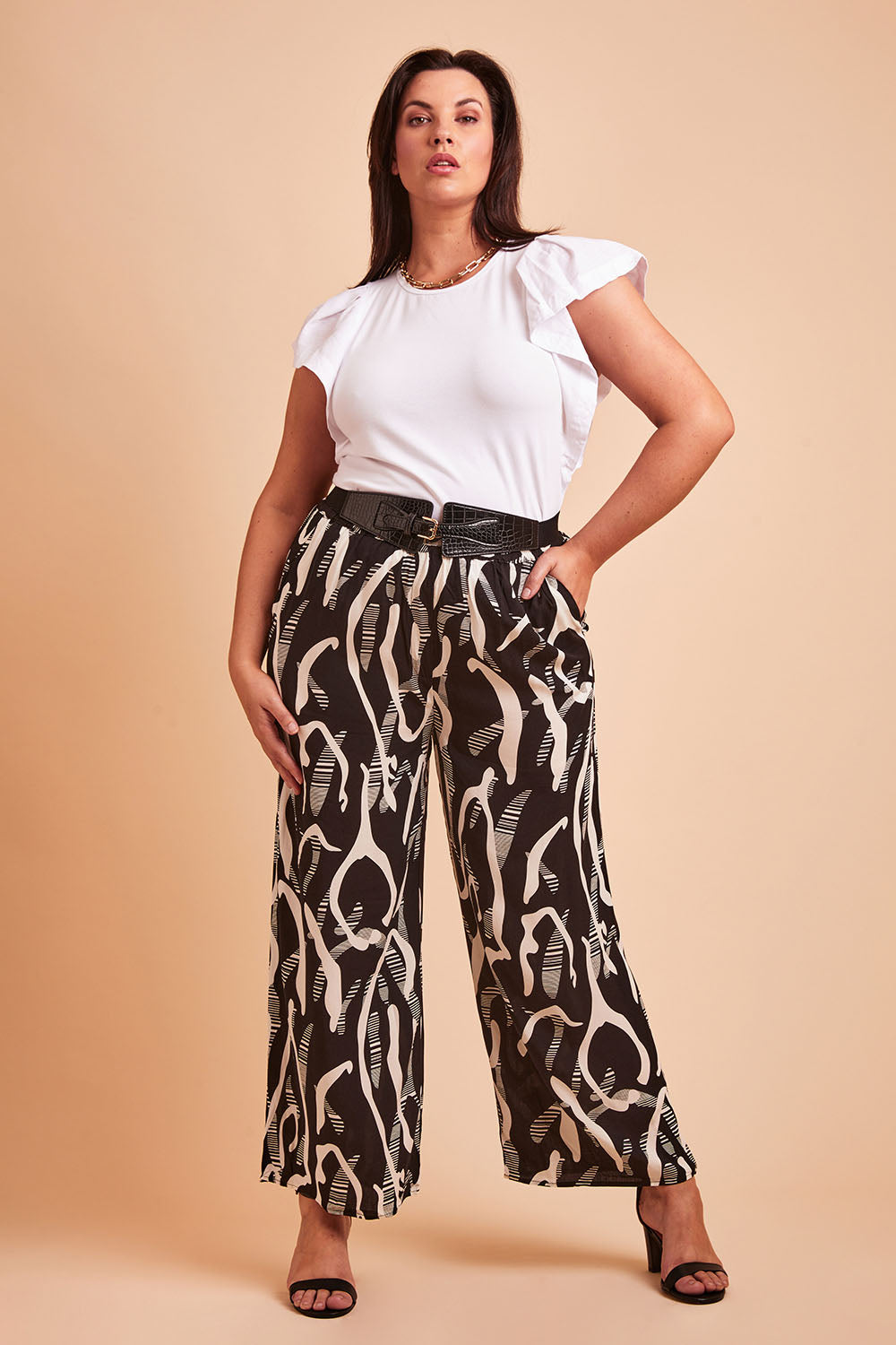 Model Poppy wearing size 16 of the Belle Relaxed Wide Leg Pull On Pant in colour Blackivory (Black), from the front, showing the whole outfit