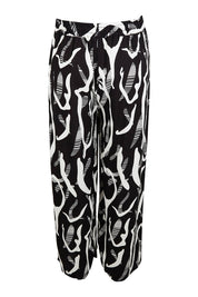 Product shot of the Belle Relaxed Wide Leg Pull On Pant in colour Blackivory (Black), from the back