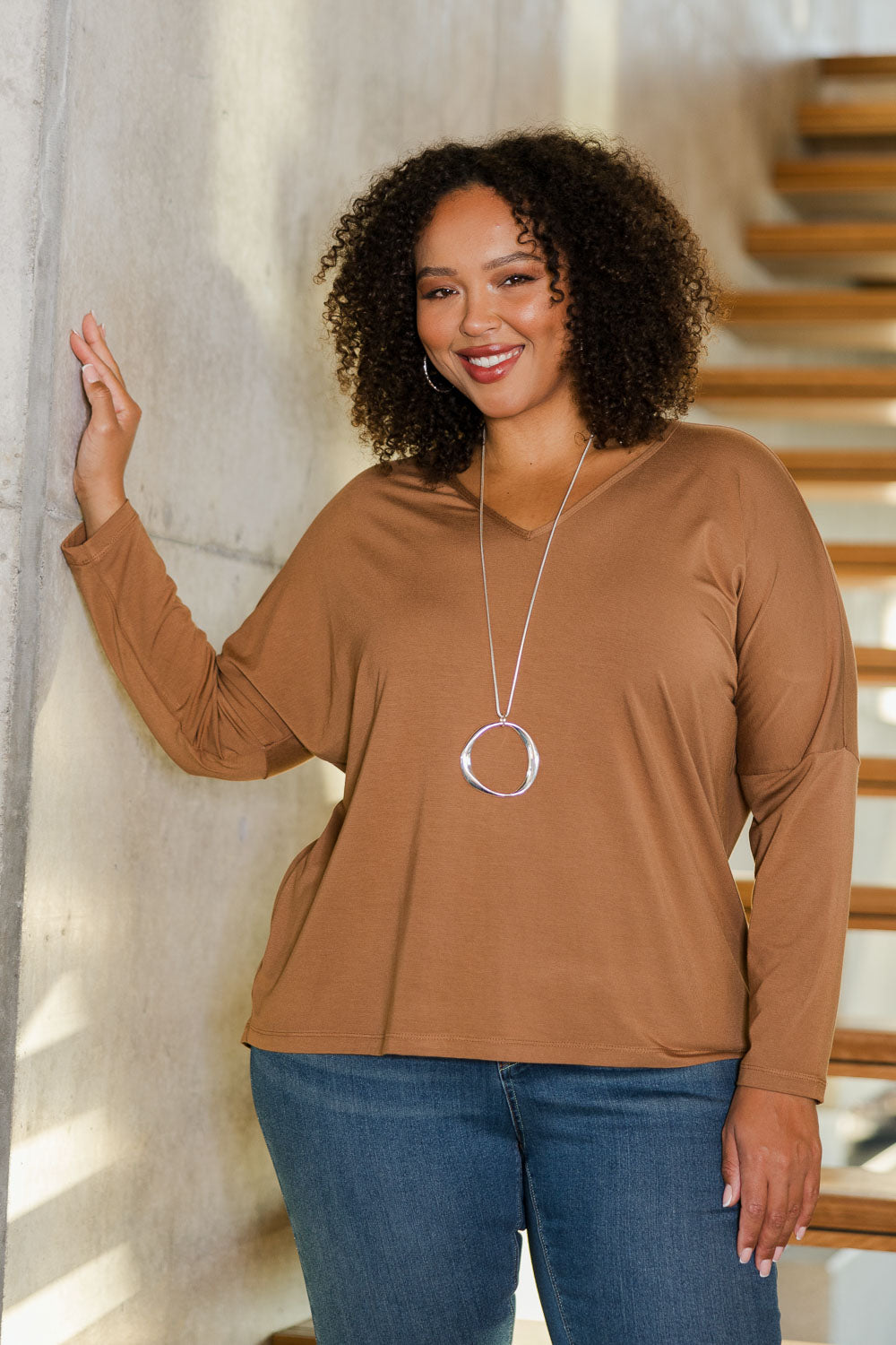 Model Alexis wearing size 18 of the Belle Luxe Bamboo V Neck Tee in colour Tawny, from the front, showing the whole outfit