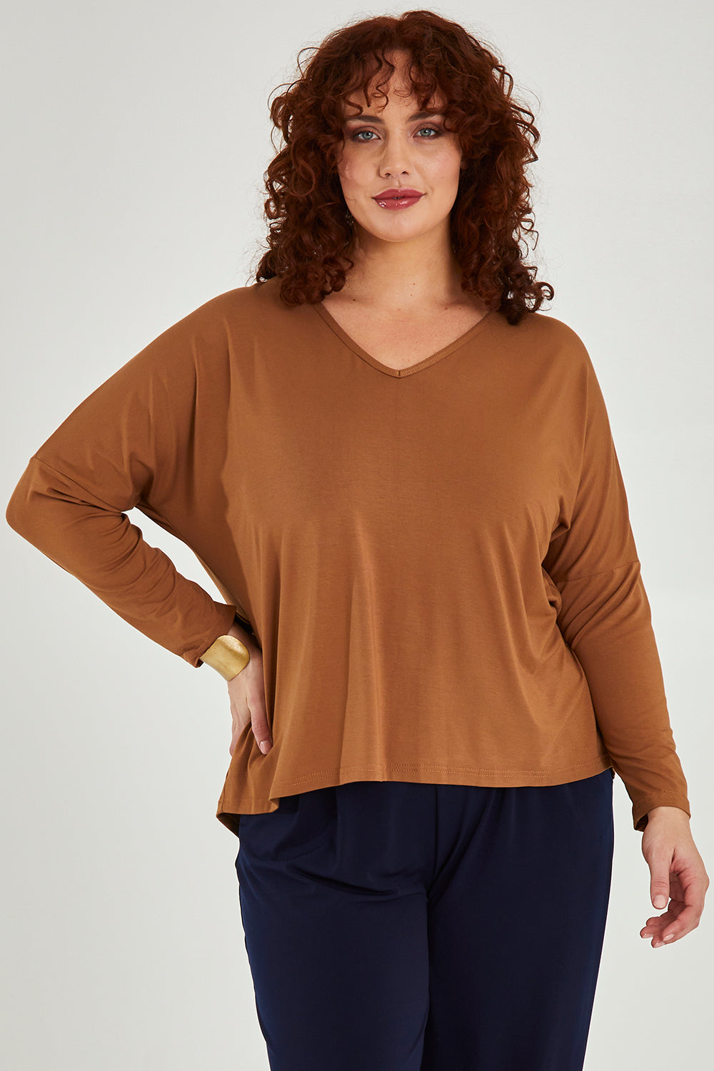 Model Maddy wearing size 16 of the Belle Luxe Bamboo V Neck Tee in colour Tawny, from the front, cropped image