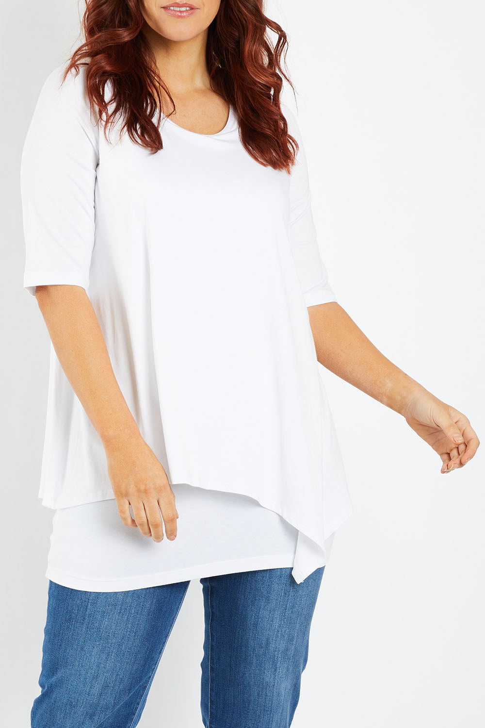 Model Laura wearing size 12 of the Belle Half Sleeve Forgiver Tunic in colour White (White), from the front, cropped image