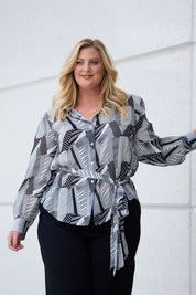 Model Caitlin wearing size 18 of the Belle Full Sleeve Printed Shirt in colour Blackivory (Black), from the front, showing the whole outfit