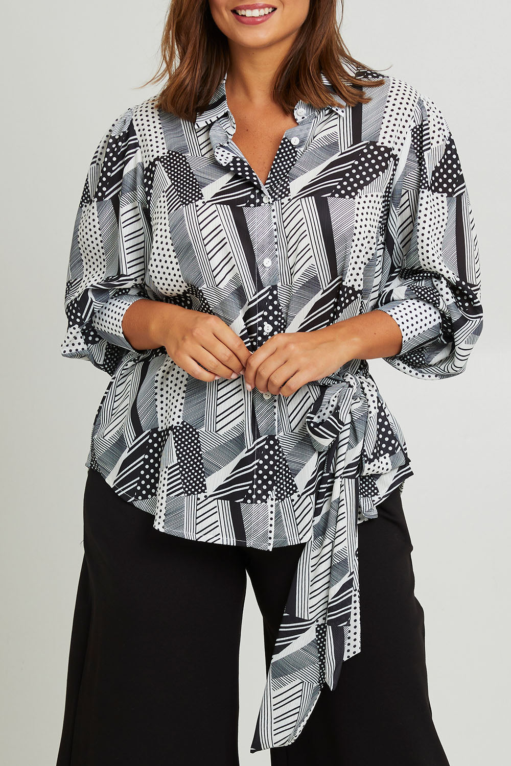 Model Monique wearing size 14 of the Belle Full Sleeve Printed Shirt in colour Blackivory (Black), from the front, cropped image