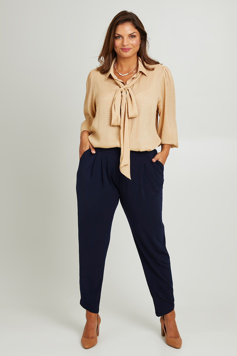 Model Monique wearing size 14 of the Belle Full Sleeve Printed Shirt in colour Tanivory, from the front, showing the whole outfit