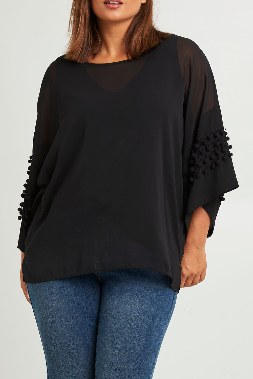 Model Monique wearing size 14 of the Belle Chiffon Bubble Detail Top w/Cami in colour Black (Black), from the front, cropped image