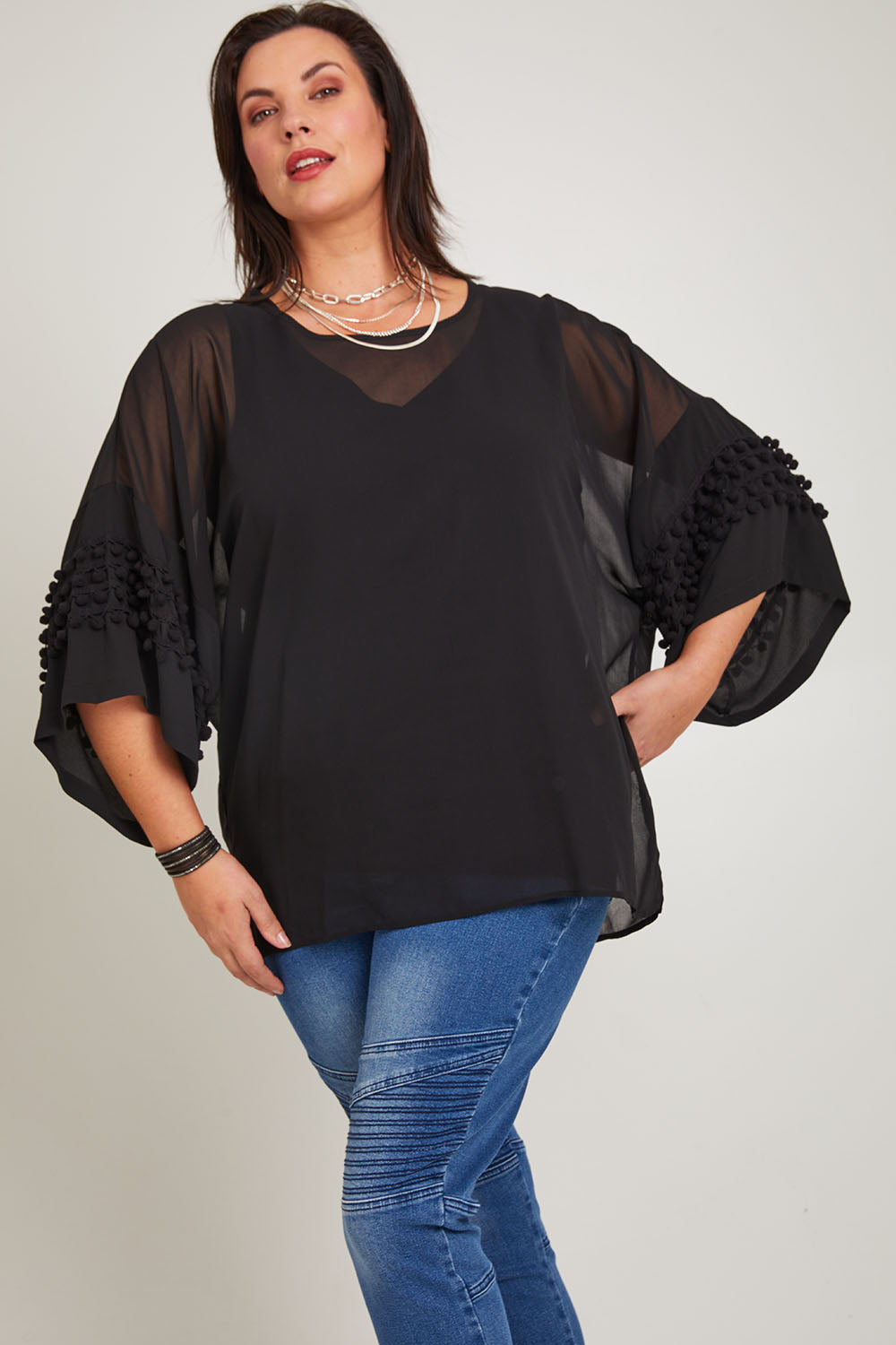 Model Poppy wearing size 16 of the Belle Chiffon Bubble Detail Top w/Cami in colour Black (Black), from the front, cropped image