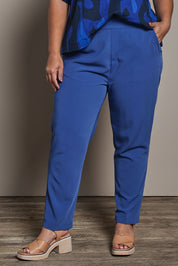 Model Ashleigh wearing size 16 of the Belle Pull On Tailored Soft Suiting  Pant in colour Ink (Blue), from the front, cropped image
