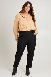Model Laura wearing size 14 of the Belle Pull On Tailored Pant in colour Black (Black), from the front, showing the whole outfit