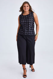 Model Monique wearing size 14 of the Belle Lined Embroided Tank in colour Black (Black), from the front, showing the whole outfit