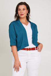 Model Poppy wearing size 16 of the Belle Cotton Sateen Cropped Jacket in colour Jewelblue (Blue), from the front, cropped image