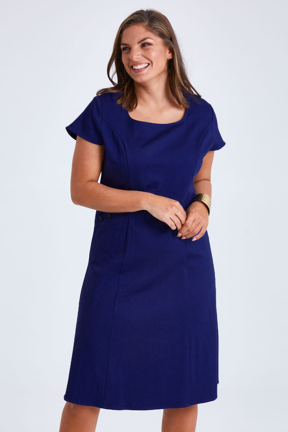 Model Monique wearing size 14 of the Belle A Line Cotton Sateen Dress in colour Sapphire (Blue), from the front, cropped image