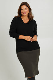 Model Monique wearing size 14 of the Belle Textured Pull On Skirt in colour Pinegreen (Green), from the front, cropped image