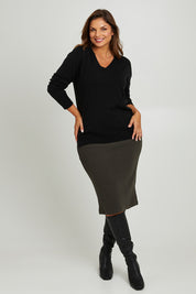 Model Monique wearing size 14 of the Belle Textured Pull On Skirt in colour Pinegreen (Green), from the front, showing the whole outfit