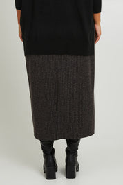 Model Monique wearing size 14 of the Belle Pull On Rib Maxi Skirt in colour Mocha, from the back