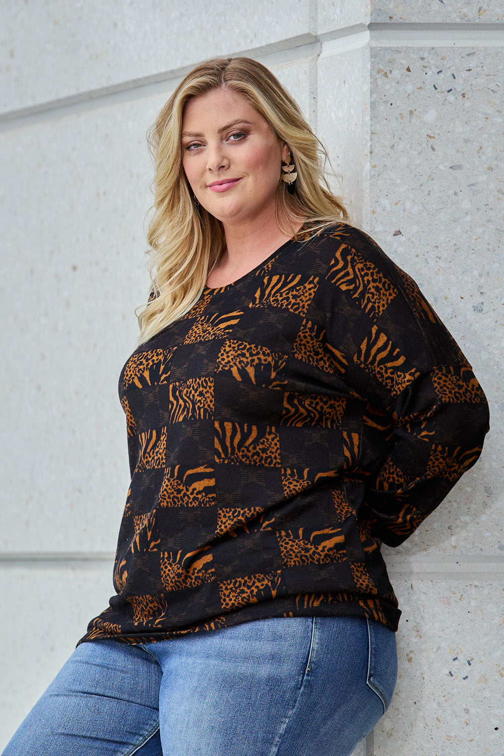 Model Caitlin wearing size 18 of the Belle Soft Knit Printed Top in colour Navytan (Blue), from the front, showing the whole outfit