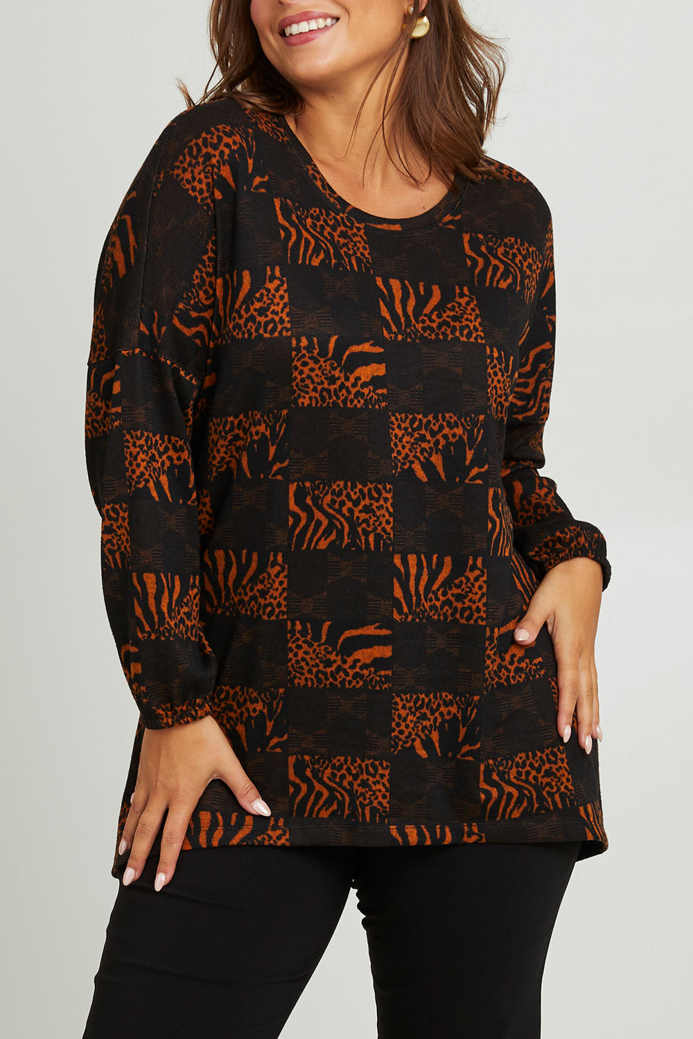Model Monique wearing size 14 of the Belle Soft Knit Printed Top in colour Navytan (Blue), from the front, cropped image