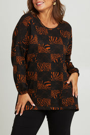 Model Monique wearing size 14 of the Belle Soft Knit Printed Top in colour Navytan (Blue), from the front, cropped image