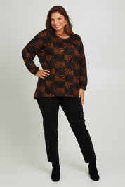 Model Monique wearing size 14 of the Belle Soft Knit Printed Top in colour Navytan (Blue), from the front, showing the whole outfit