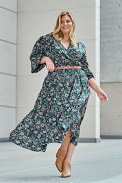 Model Caitlin wearing size 18 of the Belle X Over Maxi Dress in colour Fluergreen (Green), from the front, showing the whole outfit