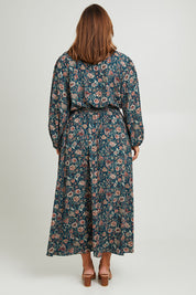 Model Monique wearing size 14 of the Belle X Over Maxi Dress in colour Fluergreen (Green), from the back