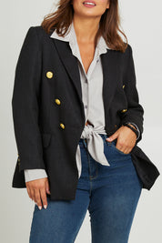 Model Monique wearing size 14 of the Belle Boucle Double Breasted Jacket in colour Black (Black), from the front, cropped image