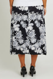 Model Monique wearing size 14 of the Belle Printed Flared Skirt in colour Blackgrey (Black), from the back