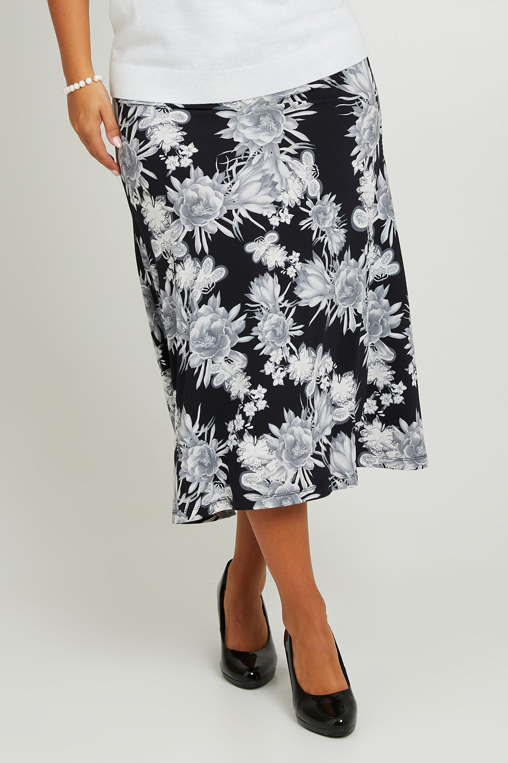 Model Monique wearing size 14 of the Belle Printed Flared Skirt in colour Blackgrey (Black), from the front, cropped image
