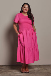 Model Ashleigh wearing size 16 of the Belle Cotton Shirred Bodice Dress in colour Candypink (Pink), from the front, showing the whole outfit