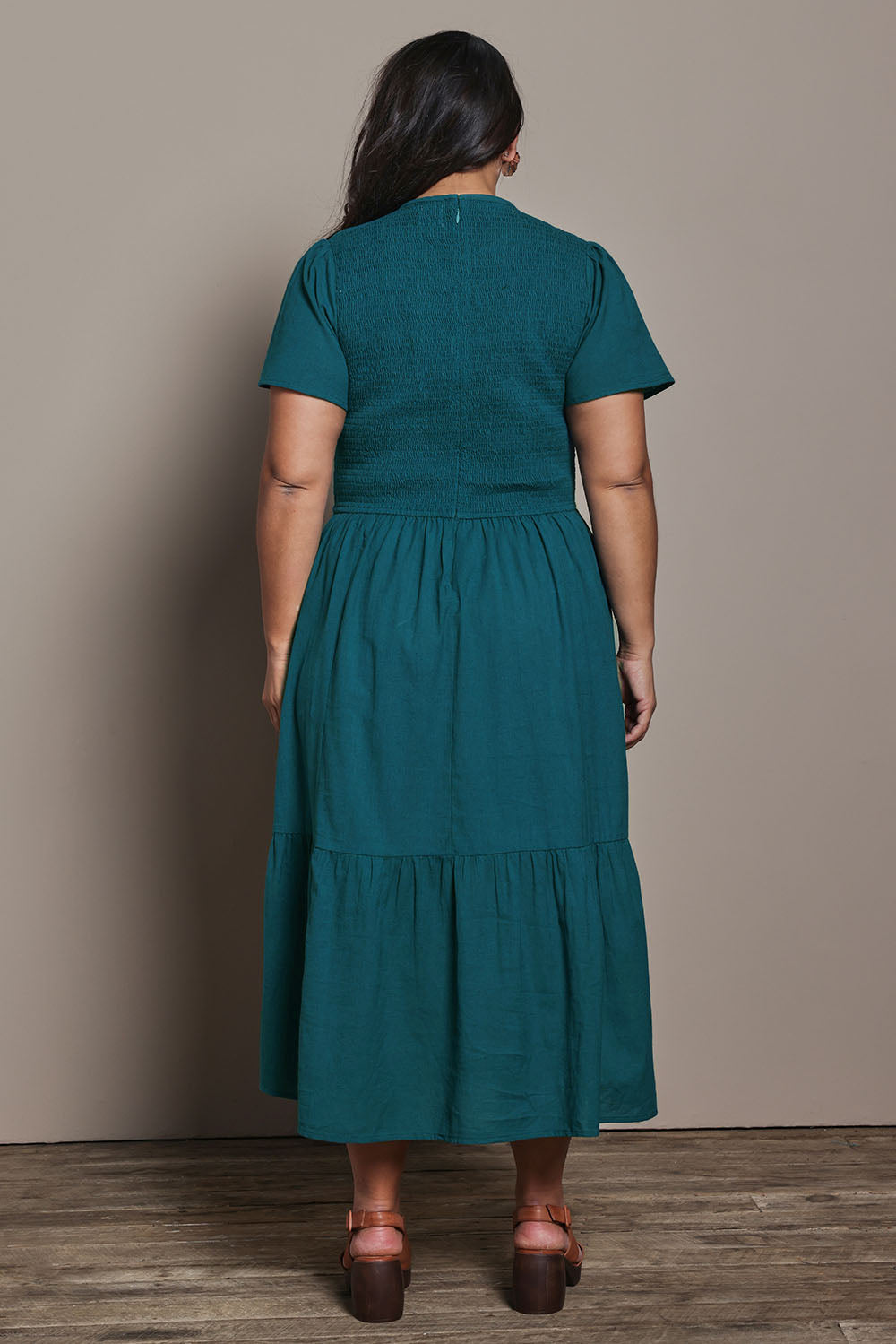 Model Ashleigh wearing size 16 of the Belle Cotton Shirred Bodice Dress in colour Deepocean (Green), from the back