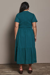 Model Ashleigh wearing size 16 of the Belle Cotton Shirred Bodice Dress in colour Deepocean (Green), from the back