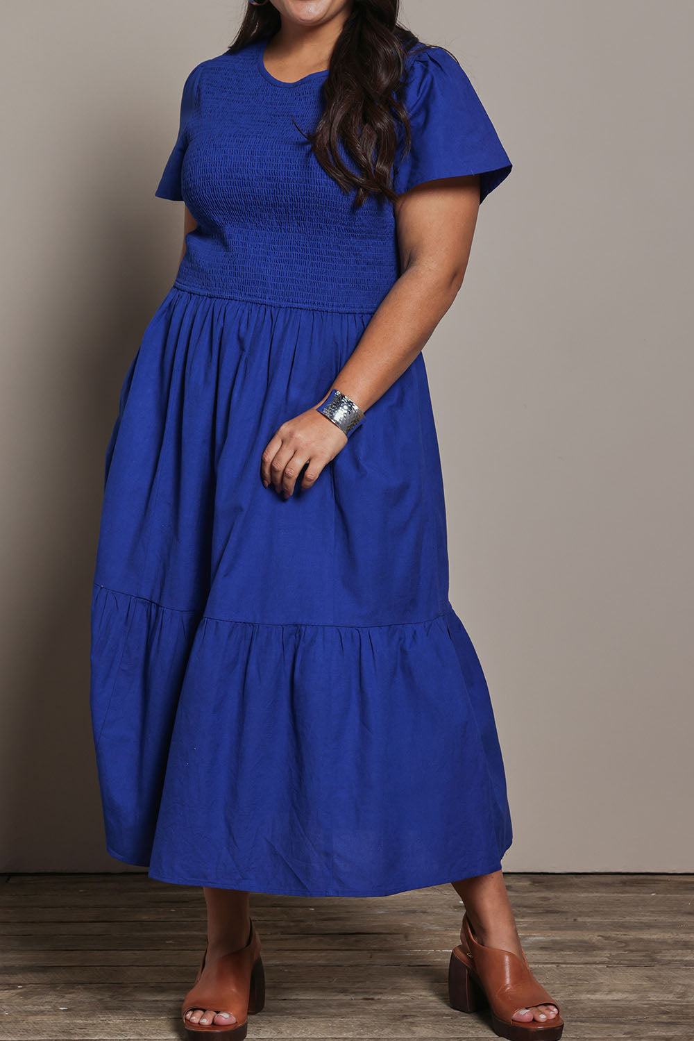 Model Ashleigh wearing size 16 of the Belle Cotton Shirred Bodice Dress in colour Marineblue (Blue), from the front, cropped image