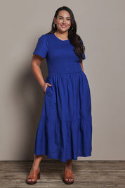 Model Ashleigh wearing size 16 of the Belle Cotton Shirred Bodice Dress in colour Marineblue (Blue), from the front, showing the whole outfit