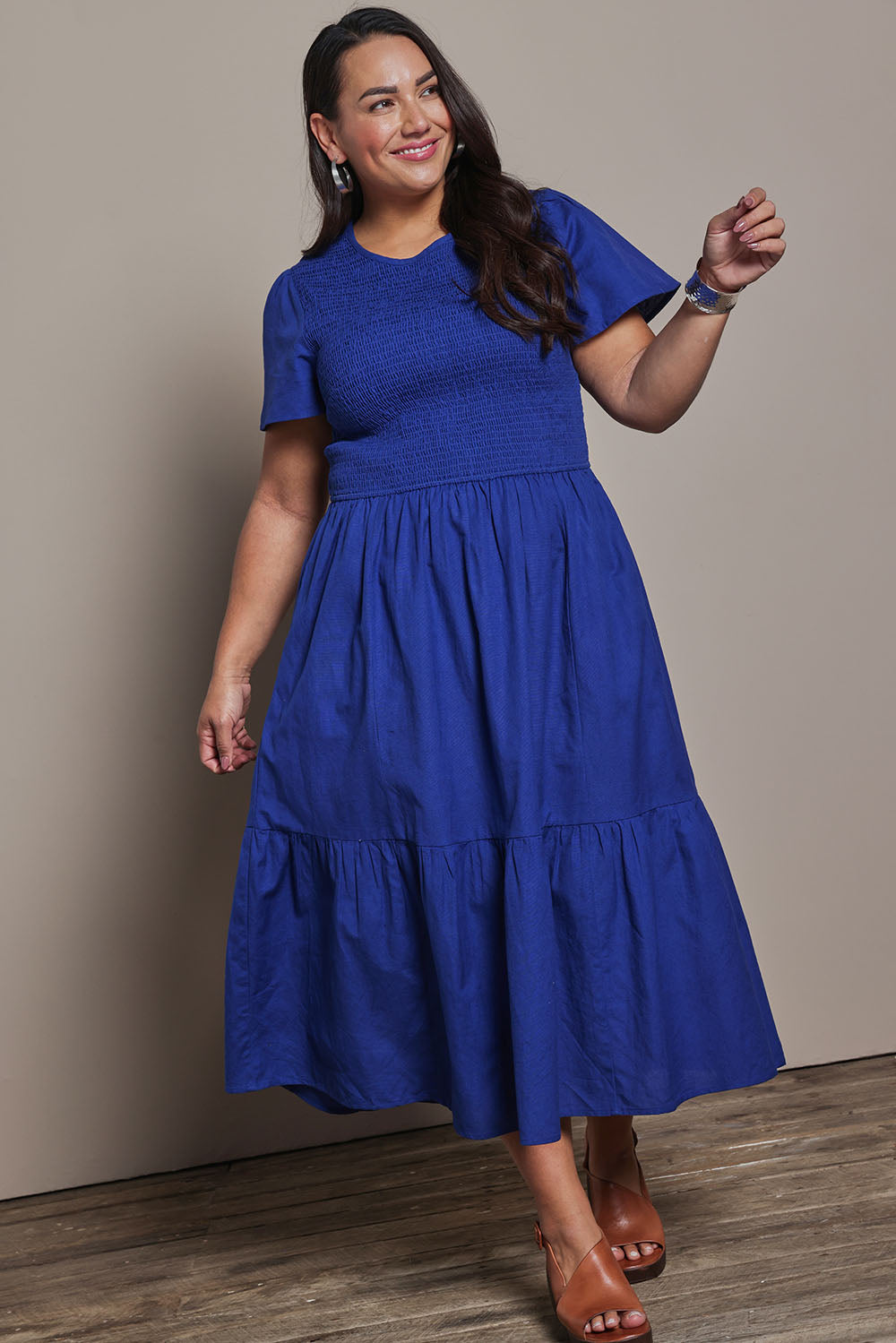 Model Ashleigh wearing size 16 of the Belle Cotton Shirred Bodice Dress in colour Marineblue (Blue), from the front, showing the whole outfit