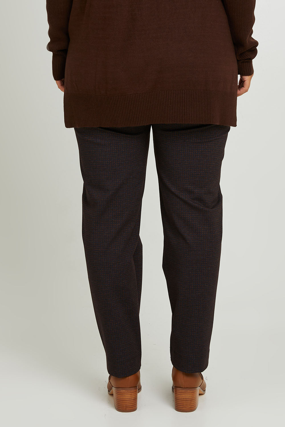 Model Monique wearing size 14 of the Belle Printed Ponte Pull On Pant in colour Ochrenavy (Blue), from the back