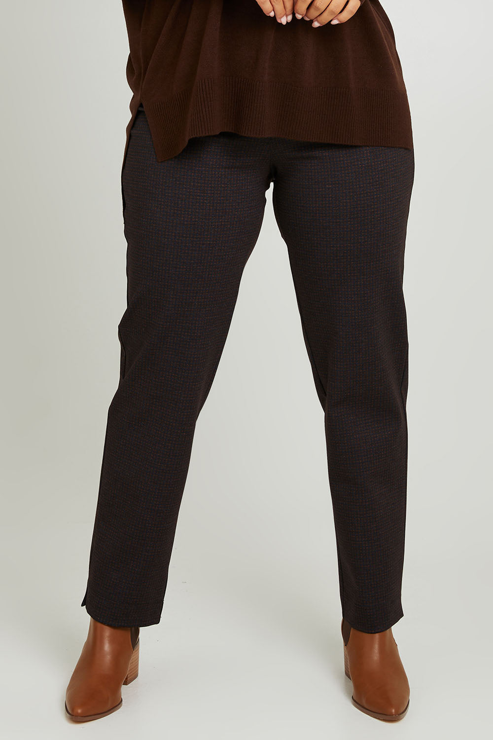 Model Monique wearing size 14 of the Belle Printed Ponte Pull On Pant in colour Ochrenavy (Blue), from the front, cropped image