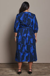 Model Ashleigh wearing size 16 of the Belle Puff Sleeve Printed  Cotton Wrap Dress in colour Trioofblue (Blue), from the back