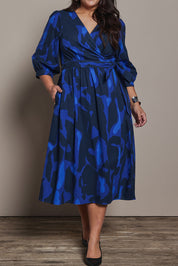 Model Ashleigh wearing size 16 of the Belle Puff Sleeve Printed  Cotton Wrap Dress in colour Trioofblue (Blue), from the front, cropped image